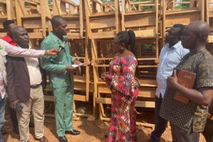 THE DISTRICT CHIEF EXECUTIVE OF AMANSIE CENTRAL DISTRICT PRESENTED DUAL DESK CHAIRS TO THE DISTRICT EDUCATION DIRECTOR ON THURSDAY, 12TH JANUARY, 2023.